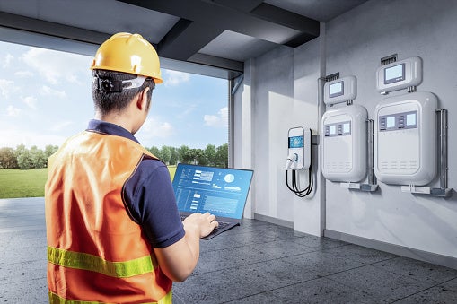 A Skilled Technician Checking the Installation of the Home EV Charger